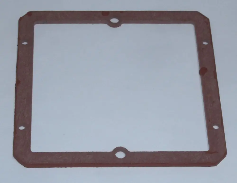 Dichtung aus rotem Material mit rechteckiger Form und mehreren Bohrungen, geeignet für Anwendungen im Zusammenhang mit Daikin-Produkten.